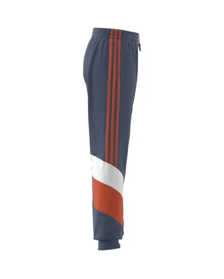 Un pantalon de survêtement tissé sport conçu en matériaux recyclés. Enfant B CB